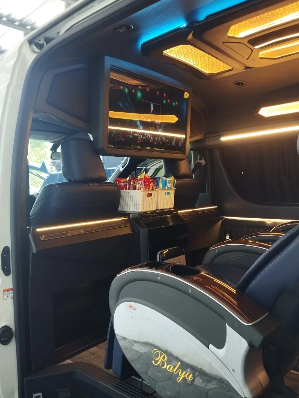Interior Hiace Executive dengan kursi kulit dan lampu ambient di plafon